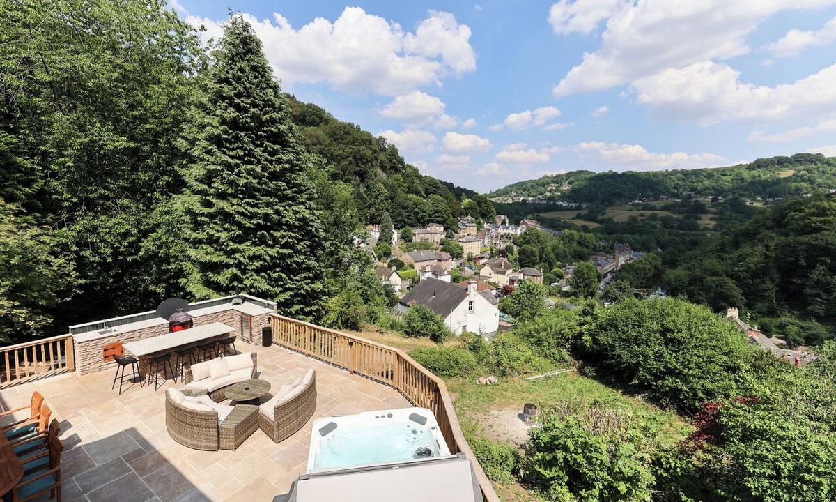 Matlock Bath House | Perched above Matlock Bath, 37 Steps is a stylish upside-down home designed to make the most of its incredible views across the valley. With a sociable open-plan living space, four ensuite bedrooms, and a showstopping terrace with hot tub.