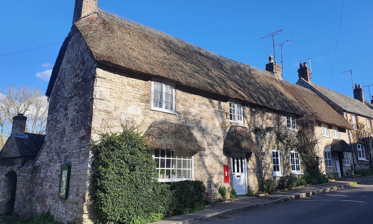 Holworth Cottage | Thatched former post office cottage in chocolate box village close to the sea