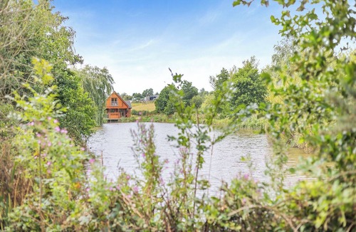 Menai Bridge Ski Chalet | Ground floor: Spacious open plan lounge, kitchen, dining area with log burner.