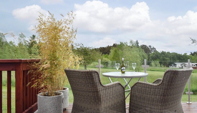 An elegant lodge with lovely raised deck to relax overlooking the golf course.