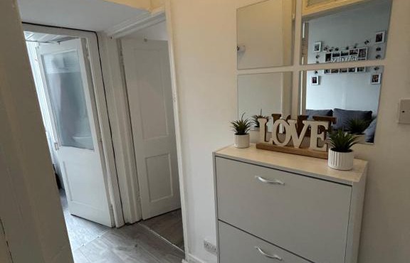 Bright bedroom with king side bed and share bathroom