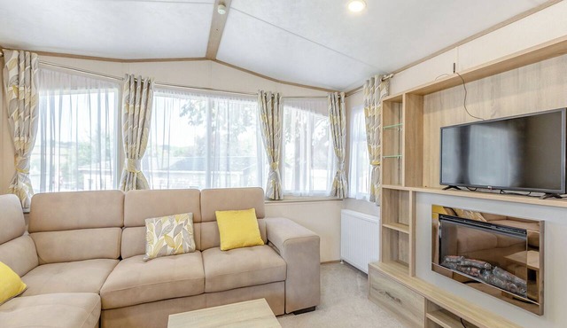 Comfortable and modern 12ft-wide caravan with one double and one twin bedroom.
